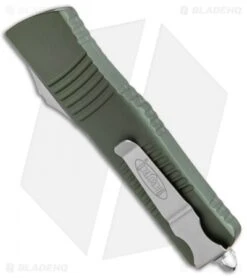 Microtech Combat Troodon OTF Knife D/E Dagger OD Green (3.8" SW Full Serr) -Microtech Shop Microtech Combat Troodon OTF DE Dagger OD Green SW Full Serr 142 12OD BHQ 98064 jr side